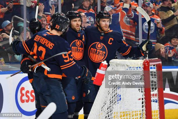 Leon Draisaitl of the Edmonton Oilers celebrates his second period goal against the Seattle Kraken with teammates Ryan Nugent-Hopkins and Connor...