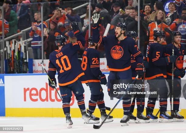 Vincent Desharnais and Derek Ryan of the Edmonton Oilers celebrate the win against the Seattle Kraken at Rogers Place on January 18, 2024 in...