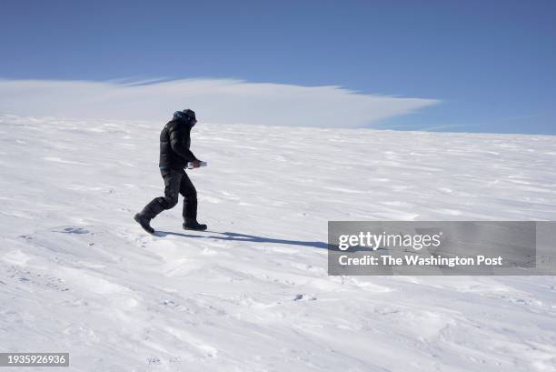 GreenDrill researcher Jason Briner carries core samples as he departs the Winkie drill camp on the edge of the ice sheet May 30, 2023 near Prudhoe...