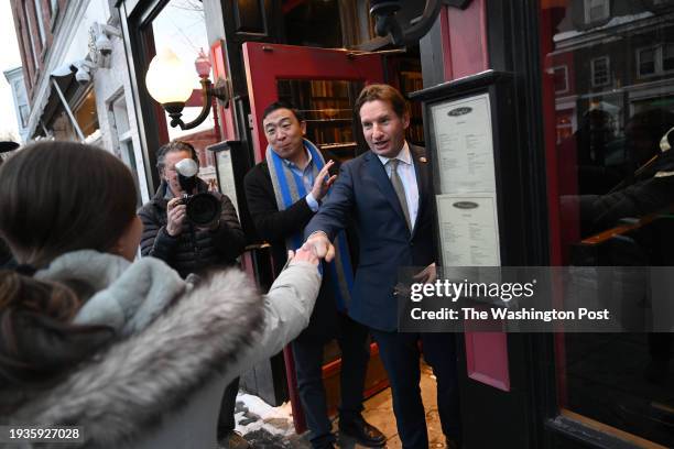 Andrew Yang and U.S. Representative Dean Phillips greet a woman outside Murphy's as Phillips meets people before holding a campaign event at Hanover...