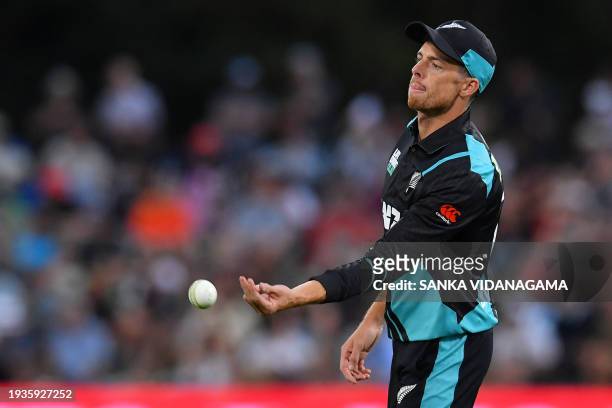 New Zealand's Mitchell Santner passes the ball during the fourth Twenty20 international cricket match between New Zealand and Pakistan at Hagley...