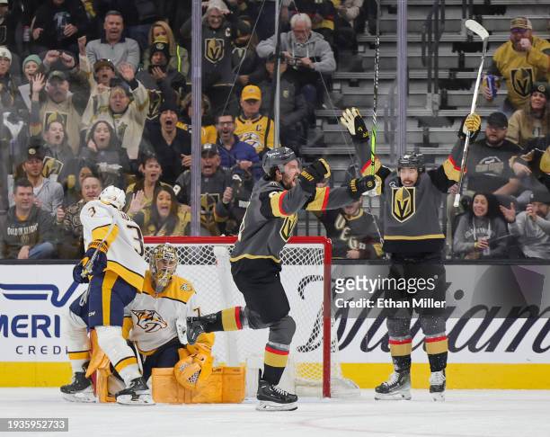 Mark Stone and Chandler Stephenson of the Vegas Golden Knights celebrate after Stone scored a goal against Jeremy Lauzon and Juuse Saros of the...