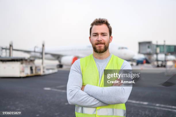 caucasian aircraft maintenance technician with hands crossed - idrottsplatspersonal bildbanksfoton och bilder