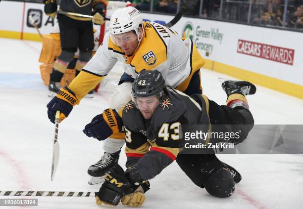 Paul Cotter of the Vegas Golden Knights battles Jeremy Lauzon of the Nashville Predators during the second period at T-Mobile Arena on January 15,...