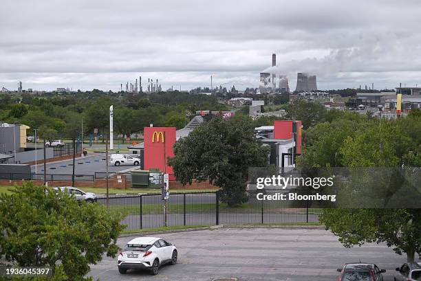 The Sasol Ltd. Secunda synthetic fuel plant beyond a McDonald's Corp. Fastfood outlet in the town of Secunda, Mpumalanga province, South Africa, on...