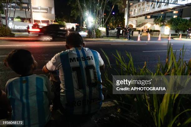 Man with his son wearing Argentina shirts wait for the arrival of Lionel Messi with the Miami FC team outside the Real Intercontinental Hotel prior...