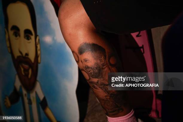 Man sports a tattoo with the face of the Argentine player Lionel Messi, waiting for the arrival of Miami FC outside the Real Intercontinental Hotel...