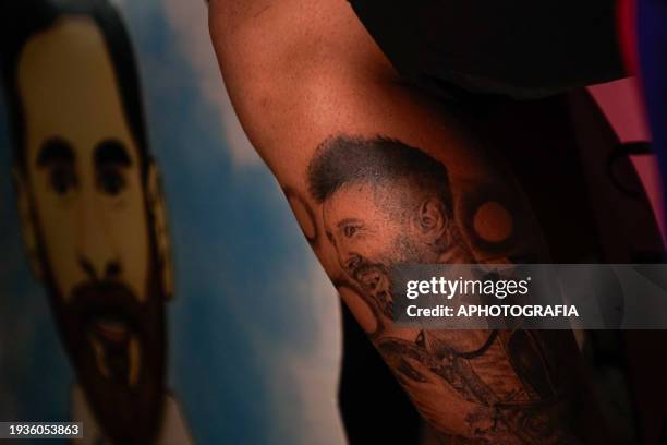 Man sports a tattoo with the face of the Argentine player Lionel Messi, waiting for the arrival of Miami FC outside the Real Intercontinental Hotel...