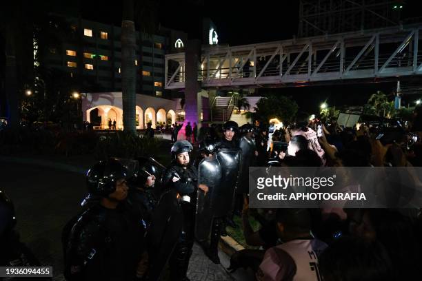 Riot police officers guard the Miami FC team hotel amongst fans on January 19, 2024 in San Salvador, El Salvador.