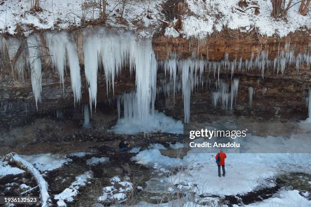 People pose for a photo while exploring the spectacular icefall Siklava Skala in Spisska Nova Ves district, Slovakia on January 16, 2024. The icefall...