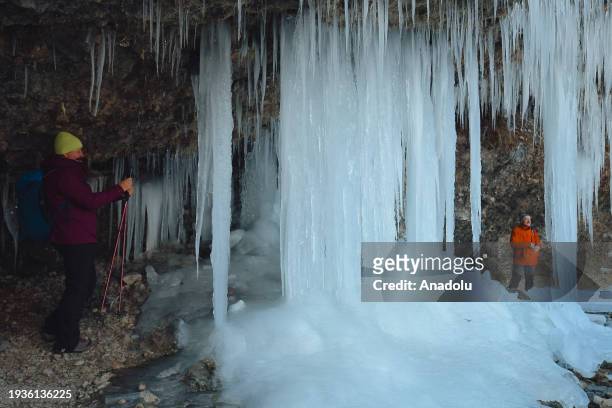 People pose for a photo while exploring the spectacular icefall Siklava Skala in Spisska Nova Ves district, Slovakia on January 16, 2024. The icefall...