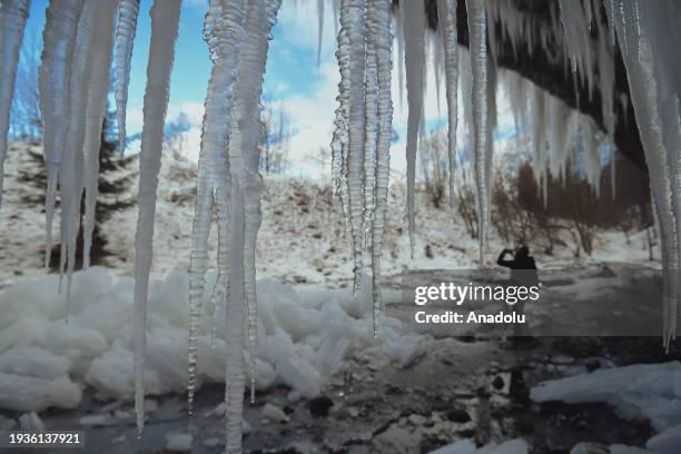 People pose for a photo while exploring the spectacular icefall Siklava Skala in Spisska Nova Ves district, Slovakia on January 16, 2024. The icefall...