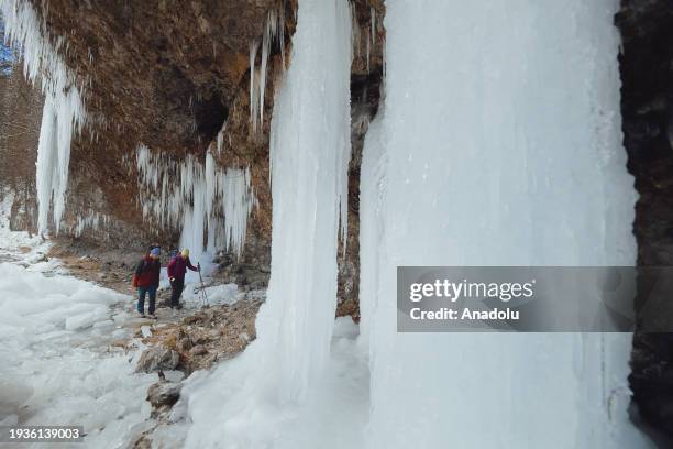 People pose for a photo while exploring the spectacular icefall Siklava Skala in Spisska Nova Ves district, Slovakia on January 16, 2024. The icefall...