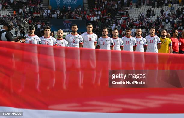 The Syrian team players are standing for the national anthem ahead of the AFC Asian Cup 2023 match between Australia and Syria at Jassim bin Hamad...