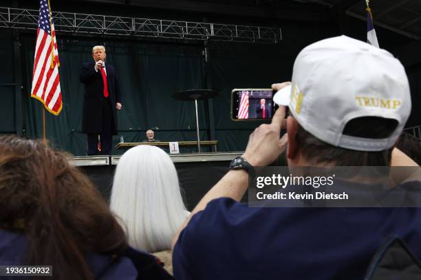 Former president Donald Trump speaks to voters during a visit to a caucus site at the Horizon Event Center on January 15, 2024 in Clive, Iowa. Iowans...