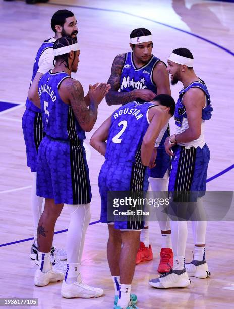 Jalen Suggs of the Orlando Magic talks with Goga Bitadze,Paolo Banchero,Chuma Okeke and Caleb Houstan before the opening tipoff against the New York...
