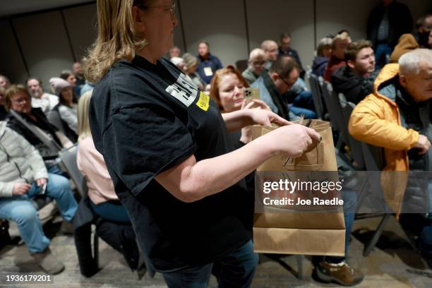 Bag of cast ballots is carried during a Republican caucus on January 15 in West Des Moines, Iowa. Iowans are voting today in the state’s caucuses for...