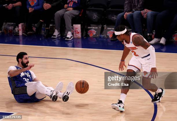 Goga Bitadze of the Orlando Magic loses his footing and the ball as Miles McBride of the New York Knicks defends in the first quarter at Madison...