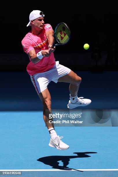 Marton Fucsovics of Hungary plays a backhand in their round one singles match against Grigor Dimitrov of Bulgaria during the 2024 Australian Open at...