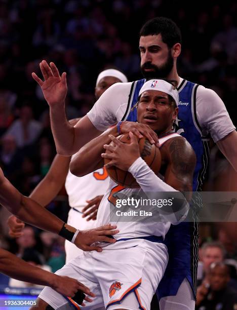 Miles McBride of the New York Knicks tries to keep the rebound as Goga Bitadze of the Orlando Magic defends at Madison Square Garden on January 15,...