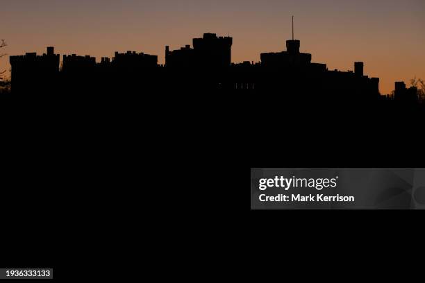 Windsor Castle is viewed in silhouette from Home Park at sunset on 18th January 2024 in Windsor, United Kingdom.