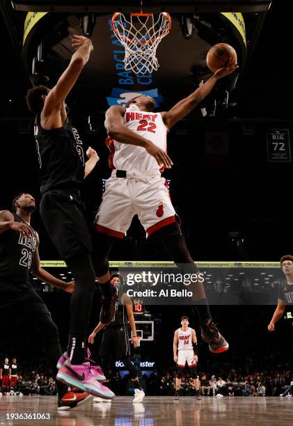 Jimmy Butler of the Miami Heat shoots against Nic Claxton of the Brooklyn Nets during their game at Barclays Center on January 15, 2024 in New York...