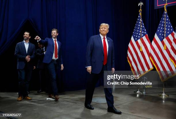 Former President Donald Trump arrives at his caucus night event, with sons Donald Trump Jr. And Eric Trump, at the Iowa Events Center on January 15,...