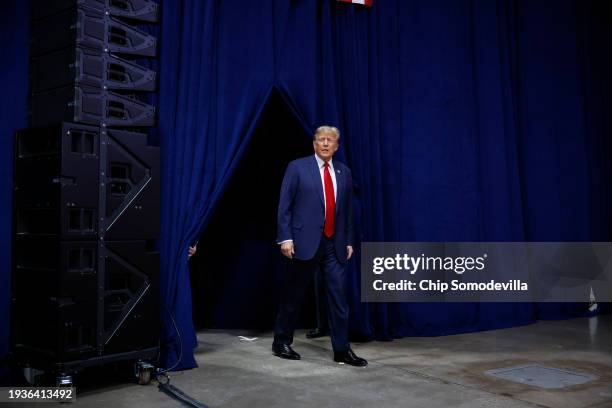 Former President Donald Trump arrives at his caucus night event at the Iowa Events Center on January 15, 2024 in Des Moines, Iowa. Iowans voted today...