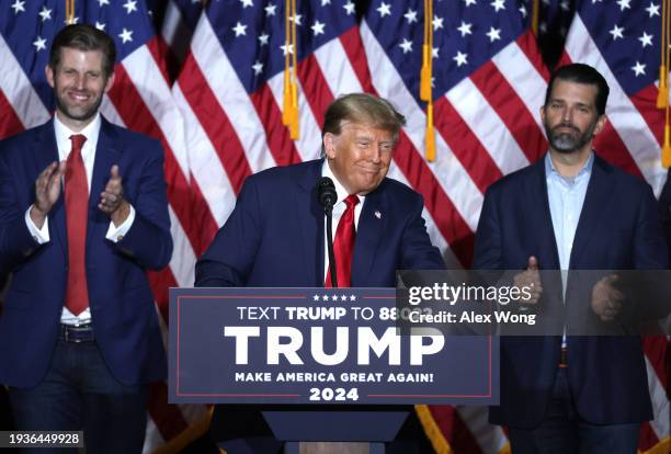 Former President Donald Trump speaks at his caucus night event, with sons Eric Trump and Donald Trump Jr. Looking on, at the Iowa Events Center on...