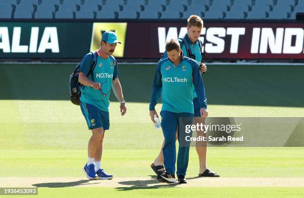Travis Head, Steve Smith and Cameron Green check the pitch as they arrive for training during the Mens Test match series between Australia and West...