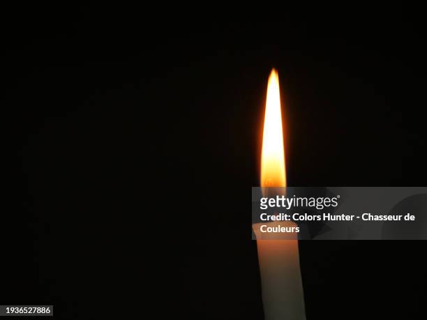 very close plan on the flame of a candle on a black background. natural light and colors. paris, france. - trust god stock pictures, royalty-free photos & images