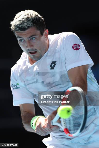 Sebastian Ofner of Austria plays a backhand in their round one singles match against Thanasi Kokkinakis of Australia during the 2024 Australian Open...