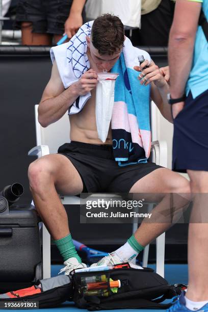 Jack Draper of Great Britain vomits after winning his round one singles match against Marcos Giron of the United States during the 2024 Australian...