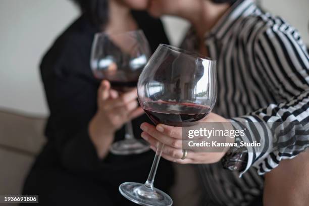 unrecognizable lgbtq couple kissing after drinking alcohol - sensualidade imagens e fotografias de stock