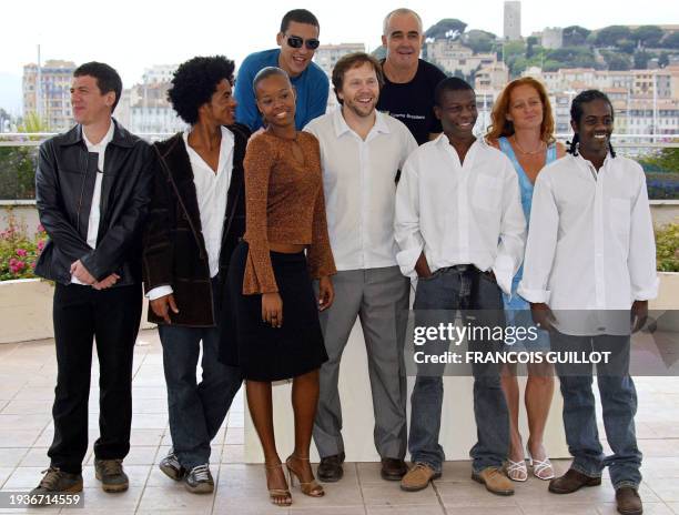Brazilian director Fernando Meirelles and co-director Katia Lund pose for photographers with the cast of their film "Cidade de Deus" with among them...