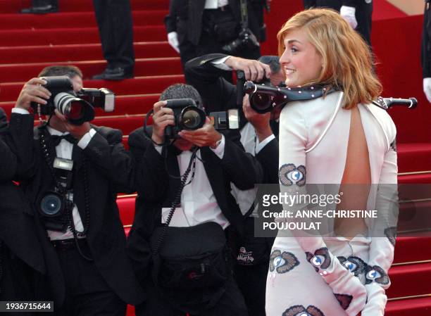 French actress Julie Gayet poses for photographers as she arrives at the Palais des festivals to attend the screening of British director Mike...