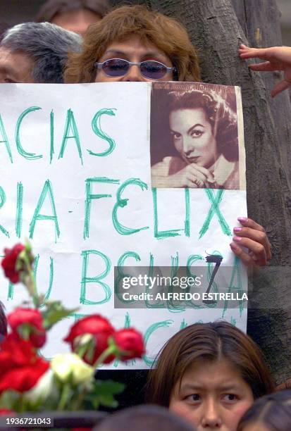 Woman is seen holding a photo of mexican actress, Maria Felix, during a memorial service in Mexico City, 09 April 2002. Felix died at the age of 88....