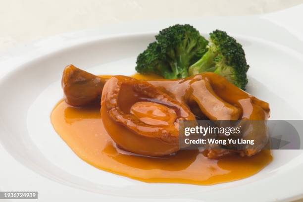 abalone chicken feet with broccoli ,chinese fine dining - abalone stock pictures, royalty-free photos & images