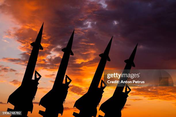 missile system on the background of the sunset. world war iii - radioaktive verseuchung stock-fotos und bilder