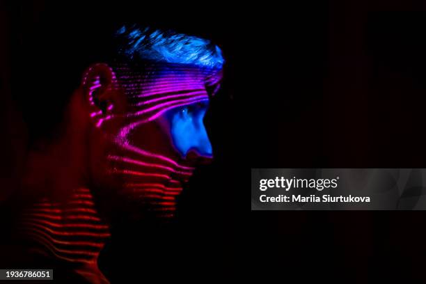 man's profile illuminated with striking neon pink light patterns. - fluorescent stock pictures, royalty-free photos & images