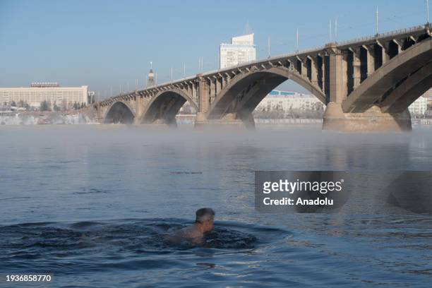 Members of the cold water swimming club Cryophile attend Epiphany bathing on the Yenisei River in the Siberian city of Krasnoyarsk at a temperature...