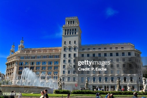 Barcelona, Plaza Catalunya several statues between the two fountains Bessones in the background the casa Pich i Pon Barcelona, Plaza Catalunya several statues between the two fountains Bessones in the background the casa Pich i Pon