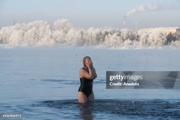 Members of the cold water swimming club Cryophile attend Epiphany bathing on the Yenisei River in the Siberian city of Krasnoyarsk at a temperature...