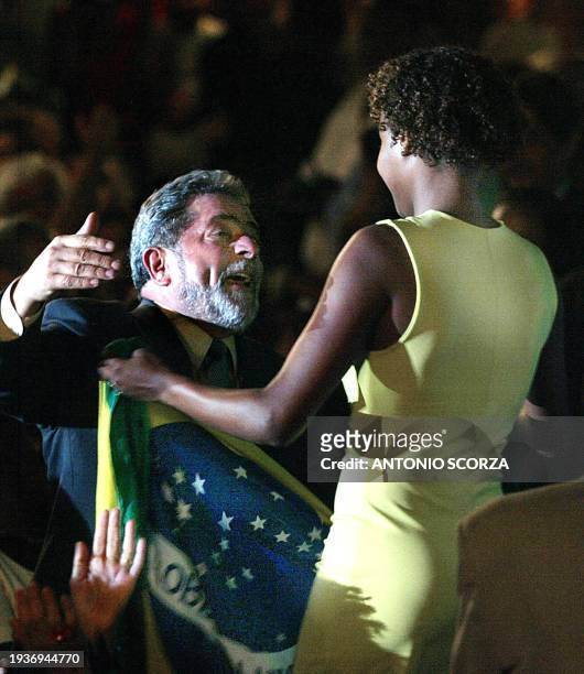 Luis Inacio Lula da Silva. Presidential candidate of Brazil for the Worker's Party, rceives the Brazilian flag from Renata Rodrigues, actress of the...