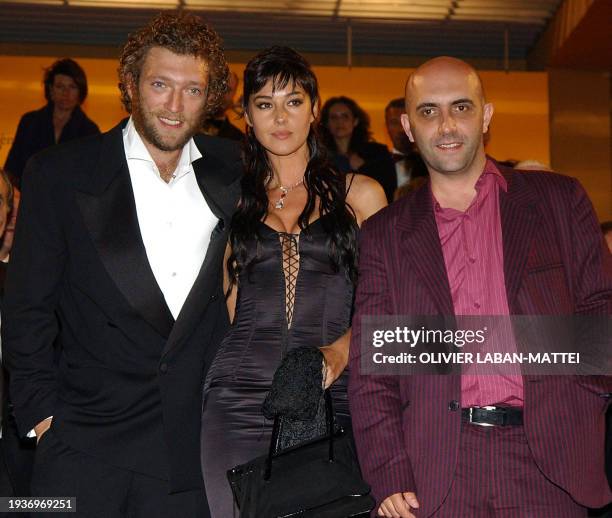 Italian actress Monica Bellucci, French actor Vincent Cassel and Argentinian director Gaspar Noé leave the palais des festivals after the screening...