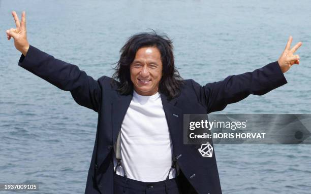 Chinese actor Jackie Chan poses for photographers during a photocall on the beach to promote his film "Around the world in 80 days" during the 56th...