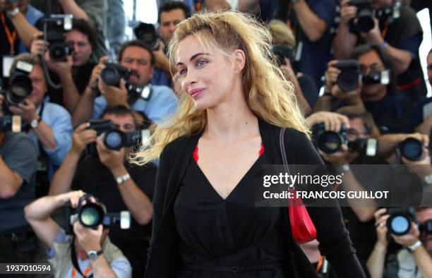 French actress Emmanuelle Beart poses for photographers on a terrace of the Palais des festivals during the photocall for "Les Egares" directed by...