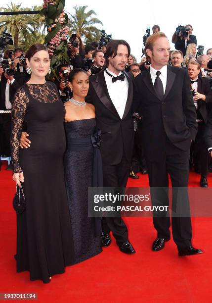 Actors Hugo Weaving, Keanu Reeves, actress Jada Pinkett-Smith and Canadian-born actress Carrie-Anne Moss pose for photographers as they arrive at the...