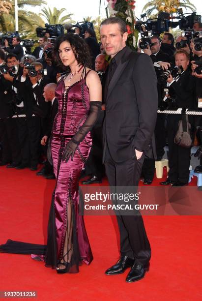 Italian actress Monica Bellucci and French actor Lambert Wilson pose for photographers as they arrive at the Palais des festivals to attend the world...