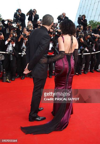 Italian actress Monica Bellucci and French actor Lambert Wilson pose for photographers as they arrive at the Palais des festivals to attend the world...